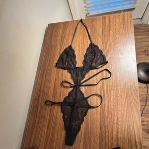 Black lace body suit with matching stockings and panties